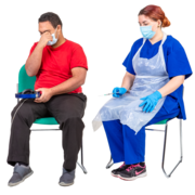 A man sitting on a chair next to a nurse with a needle.  He is looking away from the nurse.