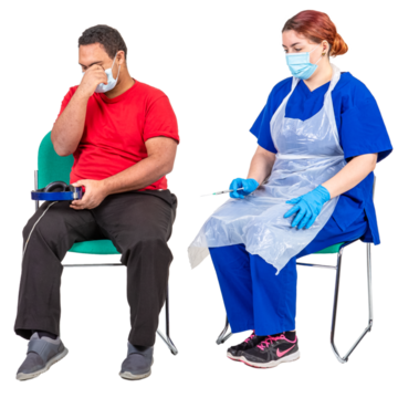 A man sitting on a chair next to a nurse with a needle.  He is looking away from the nurse.