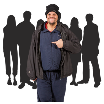 A man pointing to himself with shadows of a group of people standing behind him