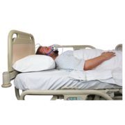 A man lying down in a hospital bed wearing an oxygen mask