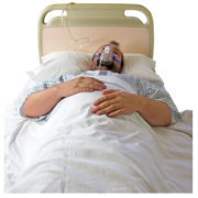 A man lying in a hospital bed wearing an oxygen mask 