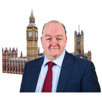 a man in a suit outside the houses of parliament