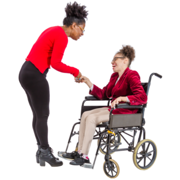 A woman smiling and shaking hands with another woman who is in a wheelchair