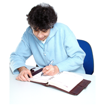 A man writing down notes in a large diary