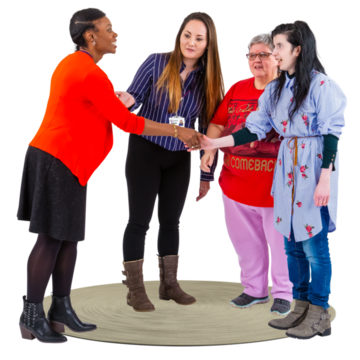 A woman meeting and shaking hands with a group of other women