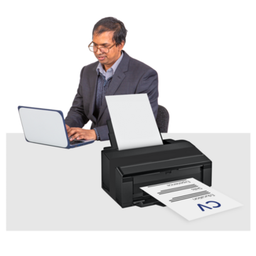 A man typing on a laptop and printing something out