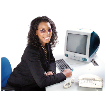 A woman in a suit at a desk with a telephone and a computer