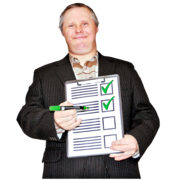A man smiles and holds a clipboard with green ticks on