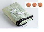 an electric blanket with 3 pennies beside it.