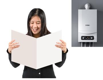 A lady reading a book.  Behind her is a boiler.