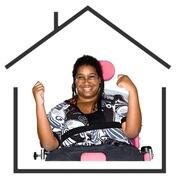 a lady in a wheelchair smiling inside an outline of a house.