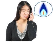 A lady on the phone.  Beside her is a speech bubble with a gas flame inside.