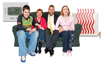 A family sitting on a sofa.  Behind them is a thermostat and a radiator which has heat coming from it.