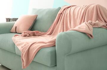 a sofa with a blanket on it