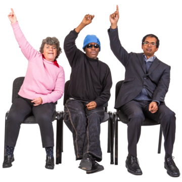 Three people sitting on chairs all have their hands up