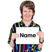 A lady holding up a card which says name.