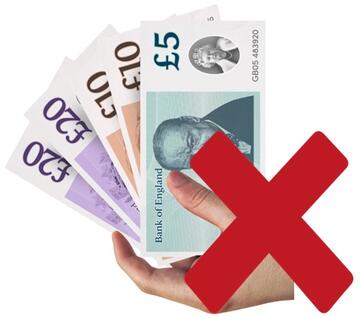 A hand holding some pound notes with a red cross beside it.