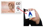 A ten pound note with an arrow pointing to a card with a gas flame on it.