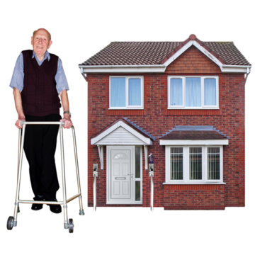 A man using a walking frame is standing outside his house