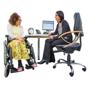 A woman in a wheelchair is talking to her doctor at her desk
