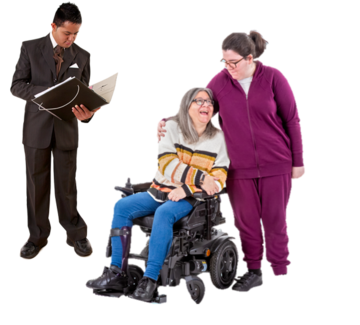 A friend puts her arm around a woman in a wheelchair whilst a man with a clipboard is writing something down