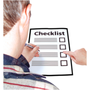 A person going through a checklist on a piece of paper.