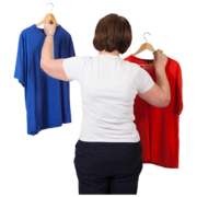 A woman holding up a blue and red shirt.