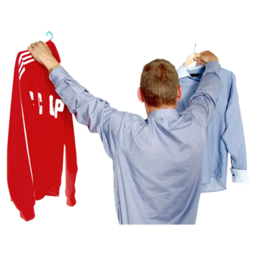 A man choosing between a casual and smart shirt.