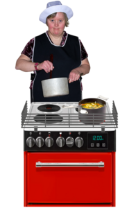 A woman is stirring a pan at an oven