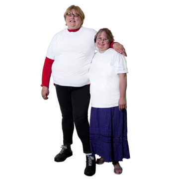 Two women hold hands.