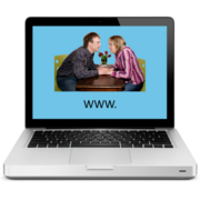 A laptop screen showing a couple holding hands at a table with www. written underneath them