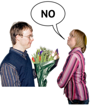 A woman saying no to a man who wants to give her flowers