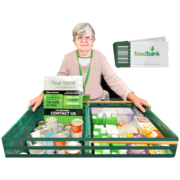 A woman holding crates of food in a food bank.