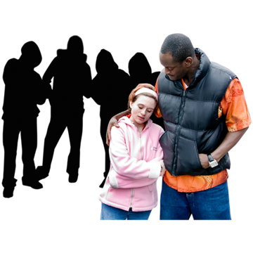 A woman talking to her friend, walking away from a group of people who have been mean to her. Her friend has his arm around her.