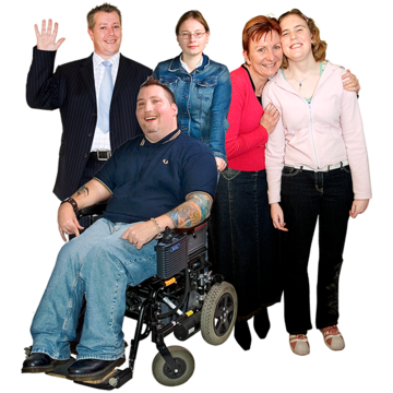 Left to right: A man in a suit, waving. A woman in a denim jacket. A woman in a red cardigan, with her arms round a girl in a pink top. A man in a wheelchair.
