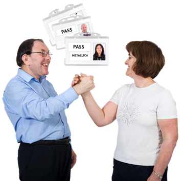 A man and a woman celebrating holding hands in front of 3 VIP passes