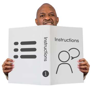 A man is reading a book with the word Instructions written on the front cover
