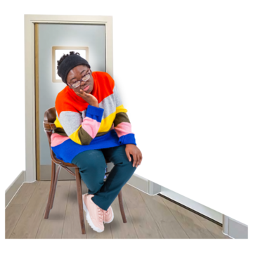 A woman sitting all alone in a room looking sad