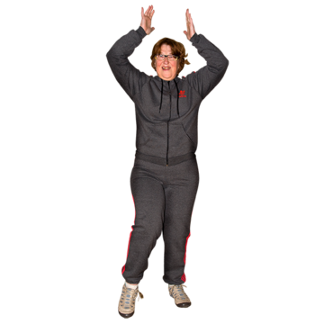 A woman is exercising with her hands over her head