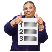 A woman holding up a piece of paper that has a list of things on it and she has her thumbs up