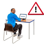 A safety warning sign above a man sitting at a desk using a laptop to surf the internet by typing www.