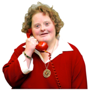 A woman holds a red telephone against her ear