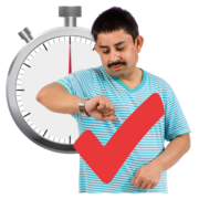 A man looks at his watch stood in front of a stopwatch and a red tick