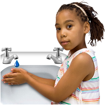 A  young girl is washing her hands at a wash basin