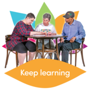 Three people sat a desk. A caption underneath says 'Keep learning'.