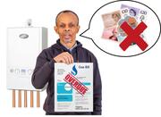 A man standing in front of a gas boiler and holding up an overdue gas bill.  He has a speech bubble with a red cross through some money.