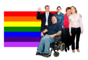 The LGBT+ flag behind a group of people