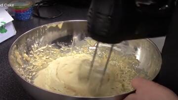 An electric whisk in a mixing bowl.