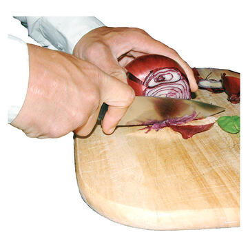 A hand holding a knife and slicing an onion on a chopping board.