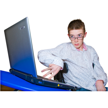 A  young man is pressing keys on a laptop